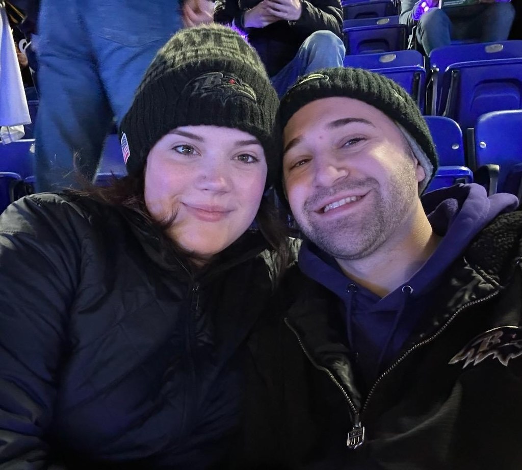 Kristin Gibbons and her husband, seated side by side in an outdoor arena.