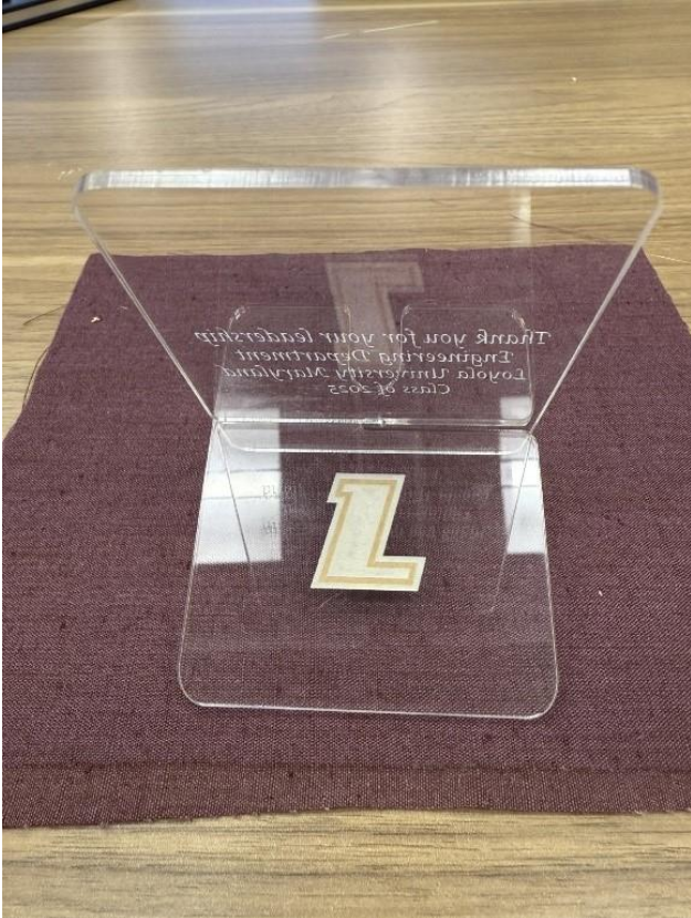 Clear acrylic phone stand with Loyola L logo engraved