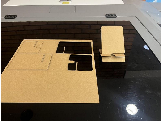 Phone stand pieces laser cut from chipboard