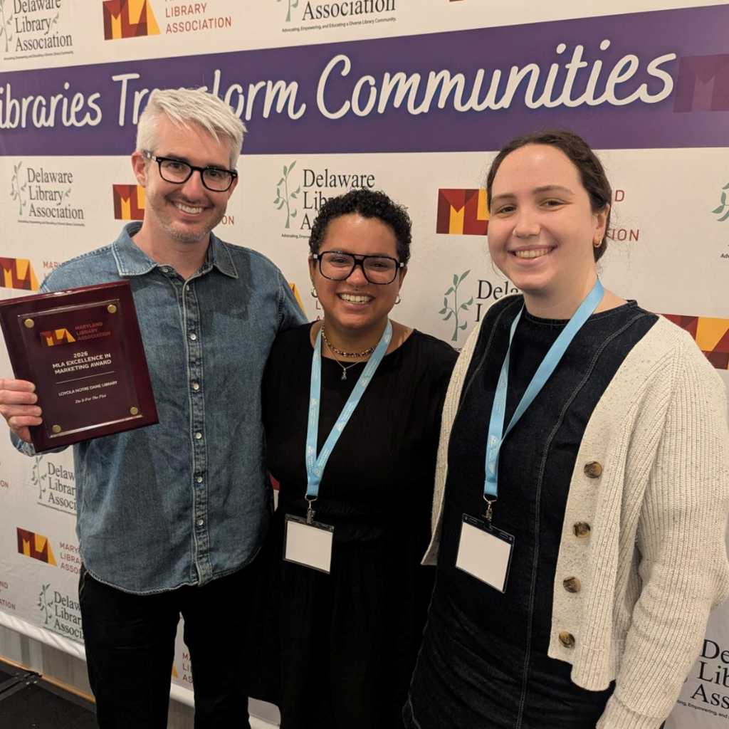 Three LNDL staff members, Jack Owen, Mallory Wareham, and Caroline Haislip, pose with an award plaque at the Maryland Library Association conference 